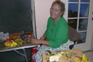 Yasoda from Badger CA., helping with garlands.