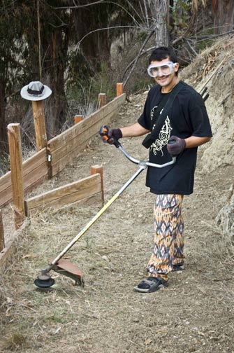 Gopal prabhu from Columbia uses the weed whacker to clear the path.