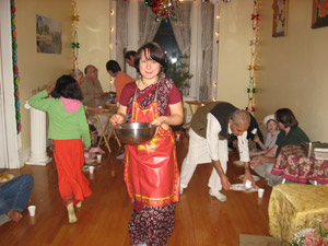 The Prasadam Feast. Nalina Sundari, a new resident of the Ladies Seva Ashram, helps to serve out prasadam.