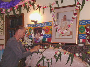 Giridhari Prabhu adding flowers to the Vyasasana.