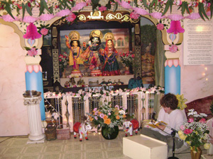 Young Ramananda Prabhu reads from Srimad Bhagavad Gita in front of Their Lordships while the decorations are being prepared.