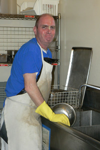 Jatindra Mohan Das working as hard as ever trying to keep the kitchen clean as the cooking accelerated.