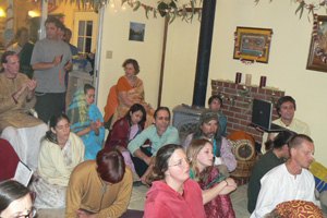 The temple room fills up with devotees wanting to hear and chant.