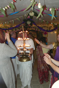 Vidura Krishna Prabhu takes the lamp to the devotees.