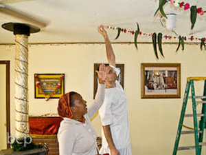 Giridhari Prabhu with his superior height helped Divyashakti Didi with the Temple room decorations.