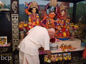 Their ever vigilant servitor Sripad Ramai Prabhu offers flowers during Arotik.