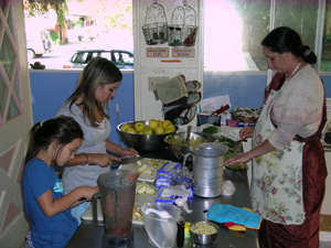 Kumaris Braja Lalana and Sumuki (granddaughters of Srutasrava and Sanatani) along with Krishnapriya Didi help with the huge amount of cut up for the feast.