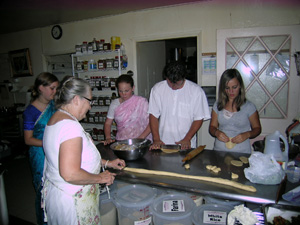 The bhoga offering is almost done as the devotees happily prepare the feast while listening to the lecture.