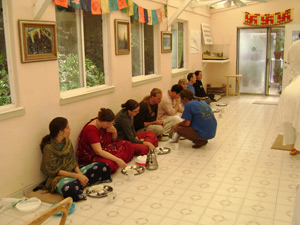 All the devotees happily honoring the Lord's prasadam.