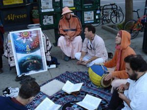 The kirtan party then moved to a new position downtown and there Kalindi Didi in record time gives out a very large stack of invitations.