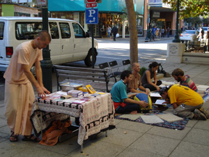 As Kamal Krishna Prabhu set up the book table downtown Santa Cruz, the Harinam Sankirtan began with Nowla Kishore and Giridhari Prabhus along with Mahadevi Didi and some curious people joined the kirtan.