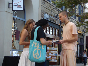 After two young girls were talking with Kamal Krsna,they sat down for a while to listen the kirtan.