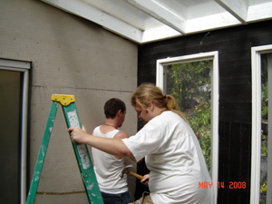 Prabhus Ramachandra and Satrughna installing cement board as a base for the ceramic tiles.