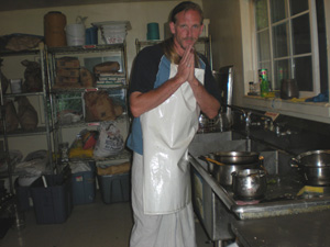 Jaya Gauranga Prabhu respectfully attends to Their Lordships cooking paraphernalia.