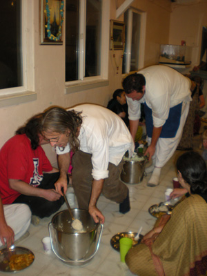 Dinatiharo Prabhu serves the rice followed by Vidura Krishna Prabhu with the dahi vada.