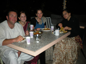 Some of the cooking crew finally get to take prasadam after serving everyone else.