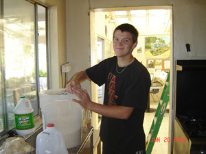 Neelamani Prabhu cleans the many buckets of grains.