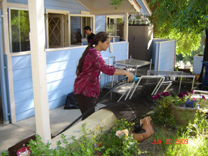 Uma Didi cleans the window screens.