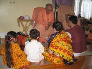 Jairam Prabhu surrounded by his family receives Srila Gurudev's divine connection via Sripad Janardan Maharaj.