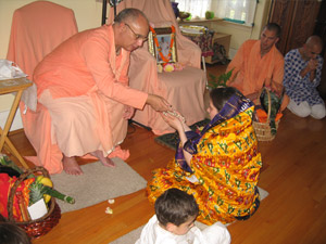 Abha Devi receives her beads.