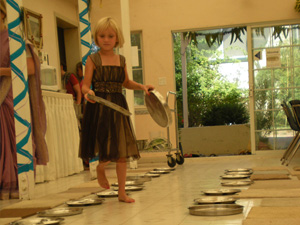 Anjali sets out the sitting mats and the plates.