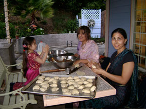 Young Lavanica helps Dhanistha and Sara roll samosas for the feast. Sara also helped to sew the beadwork on Sriman Giridhari's beautiful yellow dhoti.