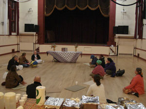 The devotees and guests gather around the altar in the big hall.