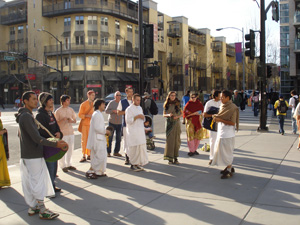 As the devotees arrived downtown the sun brought out its glow and seemed to focus on the kirtan group. 
