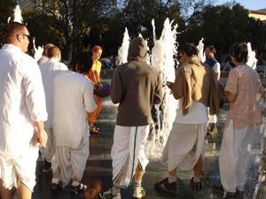 The Harinam party playfully danced back and forth through the fountain.