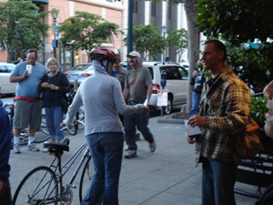 Giridhari Prabhu gives out invitations and books to passersby.