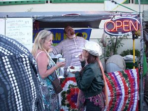 Ramachandra Prabhu attracting everyone to taste "what these Hare Krishnas are cooking-up".  Customers were very happy to hear that we were from the Seva Ashram and were grateful to eat from a clean vegetarian kitchen.