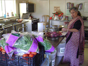 Diksavati helps with the sabji cut up.