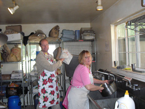 Jayananda Prabhu and Madhumati Didi help clean the pots.