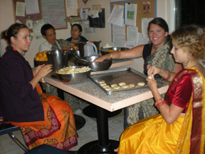 Maheswari Didi visiting from Hungary and Madhumita Didi and Krishnapriya Didi roll kachoris for the Nandotsav. 