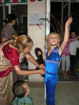 Madhumati Didi helps Anjana with her peacock costume.