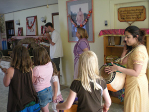 All stand to join in the kirtan for Their Lordships arotik.