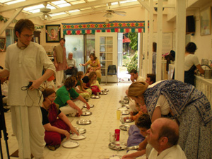 The devotees gather to honor Prasadam.