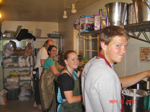 Jatindra Mohan Prabhu, Mahadevi Didi, Neelamani Prabhu and Kumari Devaki help in the kitchen with the preparations for the feast.