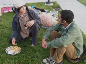 Virachandra Prabhu talks with a student and honors prasadam. 