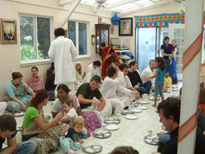 Everybody waits anxiously to honor prasadam