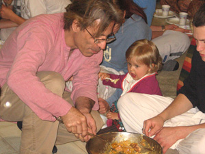 Dinatihara Prabhu never misses an opportunity to serve Prasadam.  Little Janava (with her father Gaur Nataraj Prabhu) very happily honored the Lord's remnants.