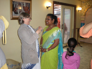 Srimati Kumkum Didi places Tulasi neckbeads on Kushmati. 